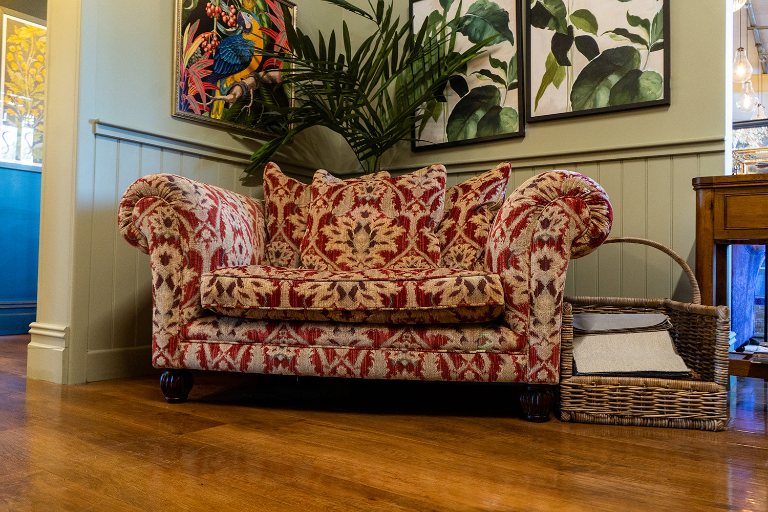 Tetrad Elgar Snuggler Sofa in Enigma Claret Fabric with deep filled seat cushions and matching scatter back cushions, curved armrests and dark wood feet