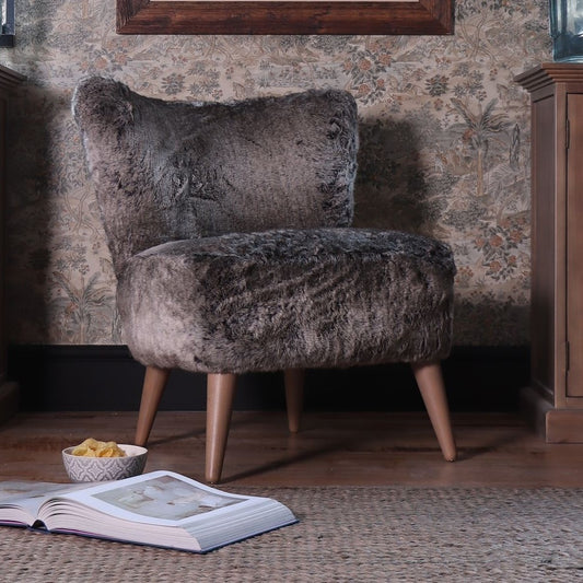 Tetrad Fairy Chair in Wolf Fur faux fur upholstery, shown complete in a furnished room.