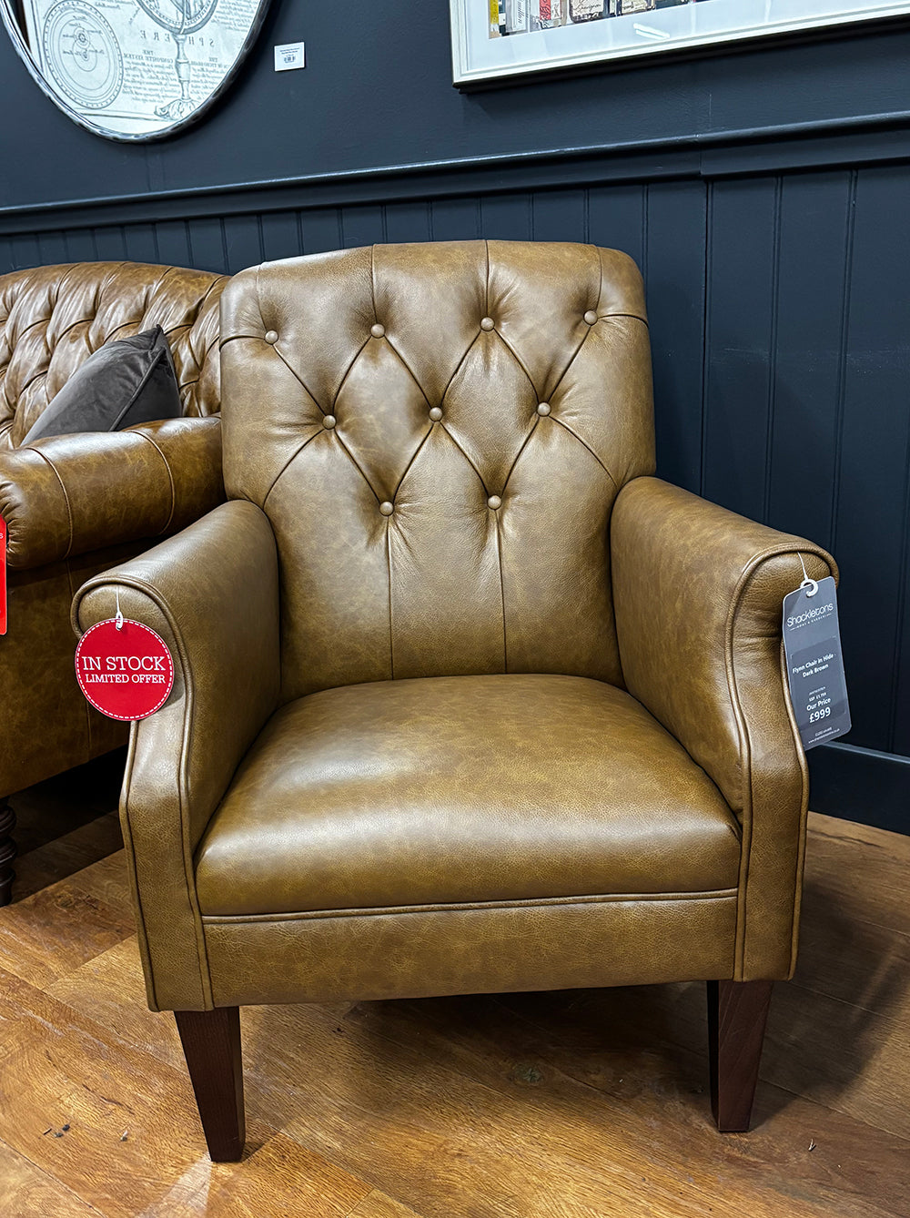 Tetrad Flynn Chair in Dark Brown Hide with deep button tufted backrest, rolled arms and dark wooden legs