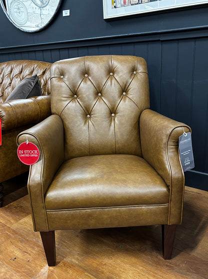 Tetrad Flynn Chair in Dark Brown Hide with deep button tufted backrest, rolled arms and dark wooden legs