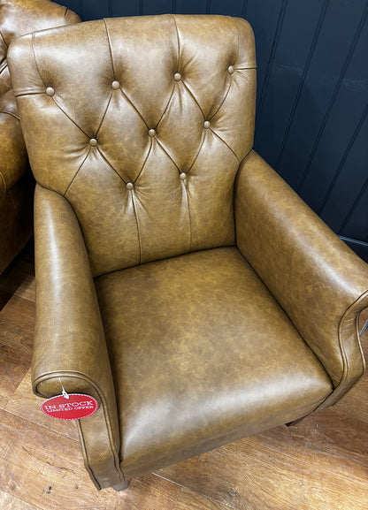Tetrad Flynn armchair in a dark brown leather, with diamond button detailing