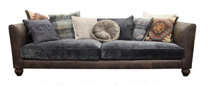 Tetrad Lowry Grand Sofa can seat 3-4 people and is crafted in premium dark brown leather and a crushed velvet upholstery, with a range of coordinating scatter back cushions