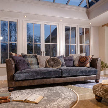 Tetrad Lowry Grand Sofa is a combination of premium Leather and sumptuous Velvet with a selection of scatter back cushions to complete the statement design