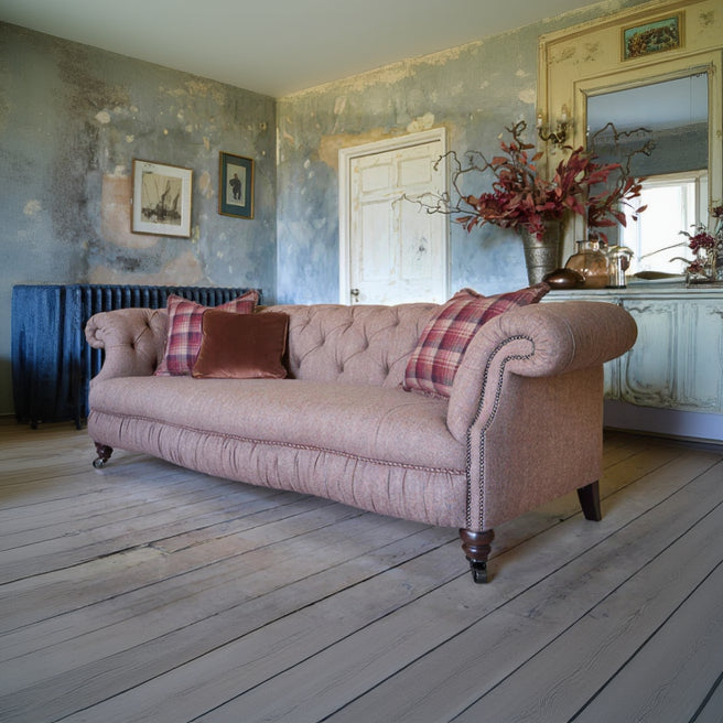 Tetrad Melrose Grand Sofa in Jura Rose an elegant soft pink toned upholstery with deep button tufting, stud detailed scrolled armrests and turned wood feet with castors