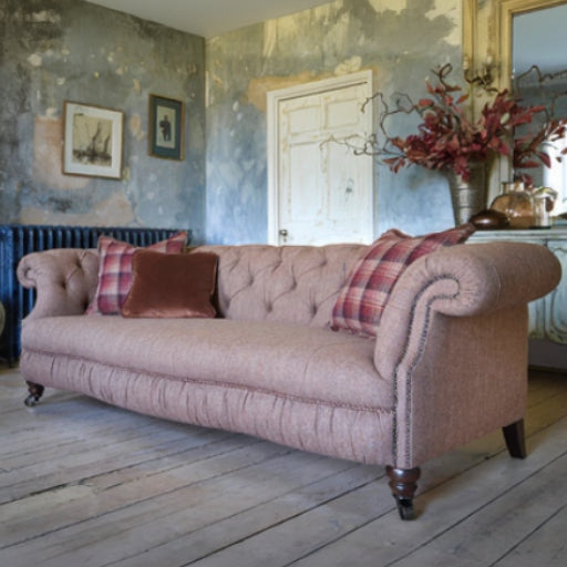 Tetrad Melrose Grand Sofa in Jura Rose colour with deep button tufting, stud detail armrests and turned wood feet with castors 