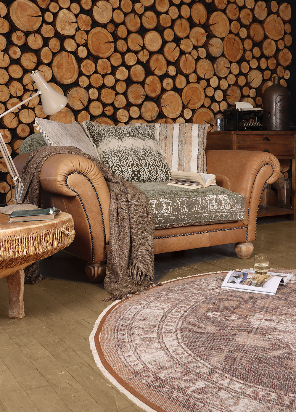 Tetrad Montana Snuggler Sofa in Atacama Nutmeg Leather seats 1-2 people with khaki and cream patterned seat cushion and scatter backs.