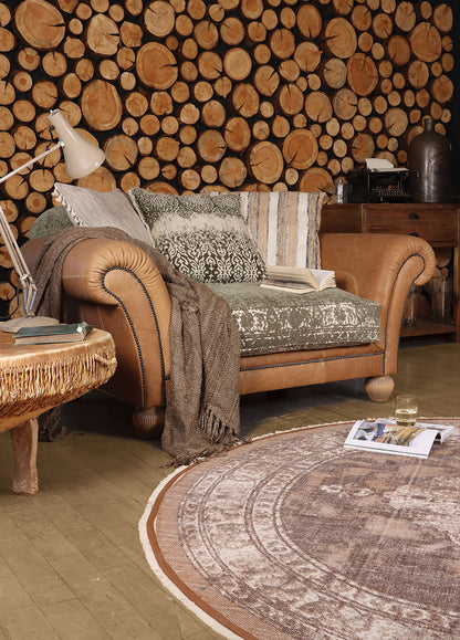 Tetrad Montana Snuggler Sofa in Atacama Nutmeg Leather seats 1-2 people with khaki and cream patterned seat cushion and scatter backs.
