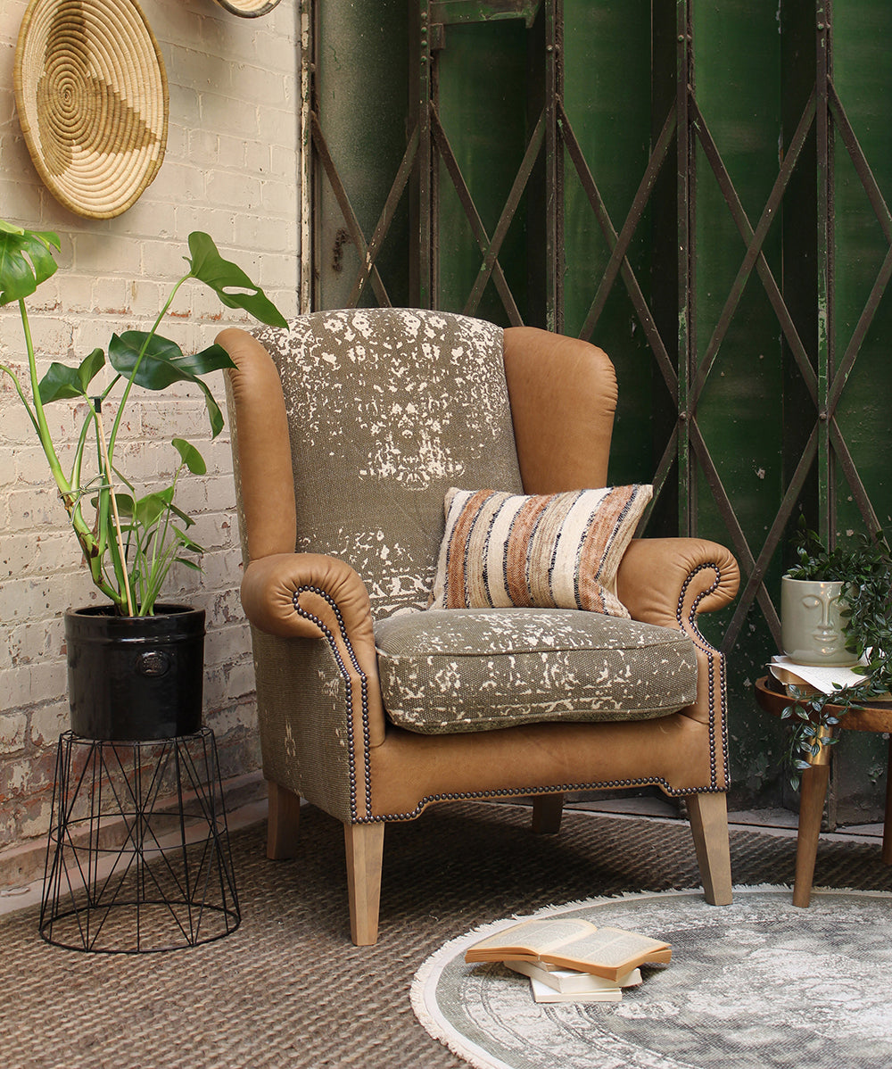 Tetrad Montana Wing Armchair in Atacama Nutmeg Leather with a sophisticated patterned fabric on the seat and inner back