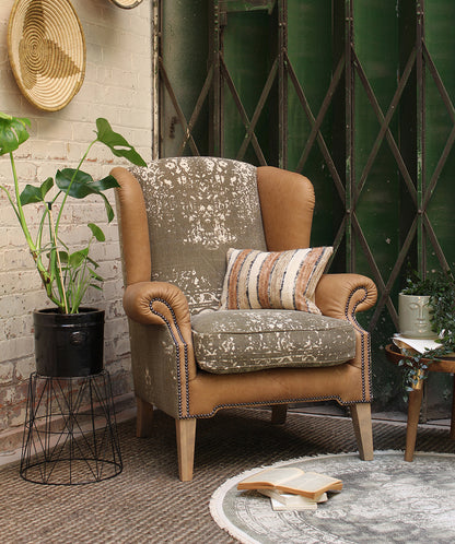 Tetrad Montana Wing Armchair in Atacama Nutmeg Leather with a sophisticated patterned fabric on the seat and inner back