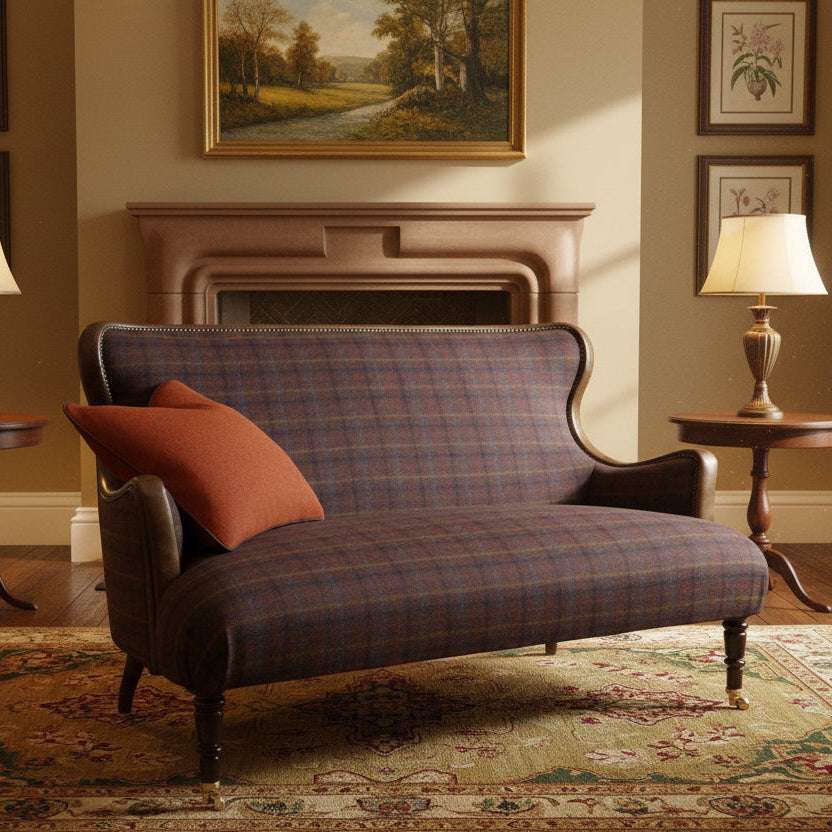 Tetrad Nairn Compact Sofa in a mixed textured check fabric with tan leather accents, brass stud detailing, dark wood turned legs and castors to the front