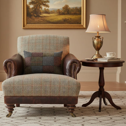 The Tetrad Taransay Ladies Chair is elegantly upholstered in Mixed Fabric and Leather accent armrests and base, brass stud detailing and dark wooden turned legs with front castors