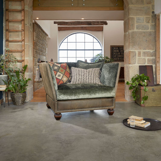 Tetrad Warwick Snuggler Sofa in Coco Velvet Olive Fabric and Comanche Timber Leather shown complete in a furnished room.