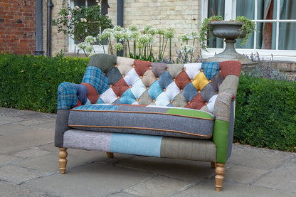 Vintage Sofa Company Alsace Patchwork Petit 2 Seater Sofa with its deep buttoned back, rolled arms and turned wooden legs, it has the charm of a traditional sofa with a more playful, individual finish.