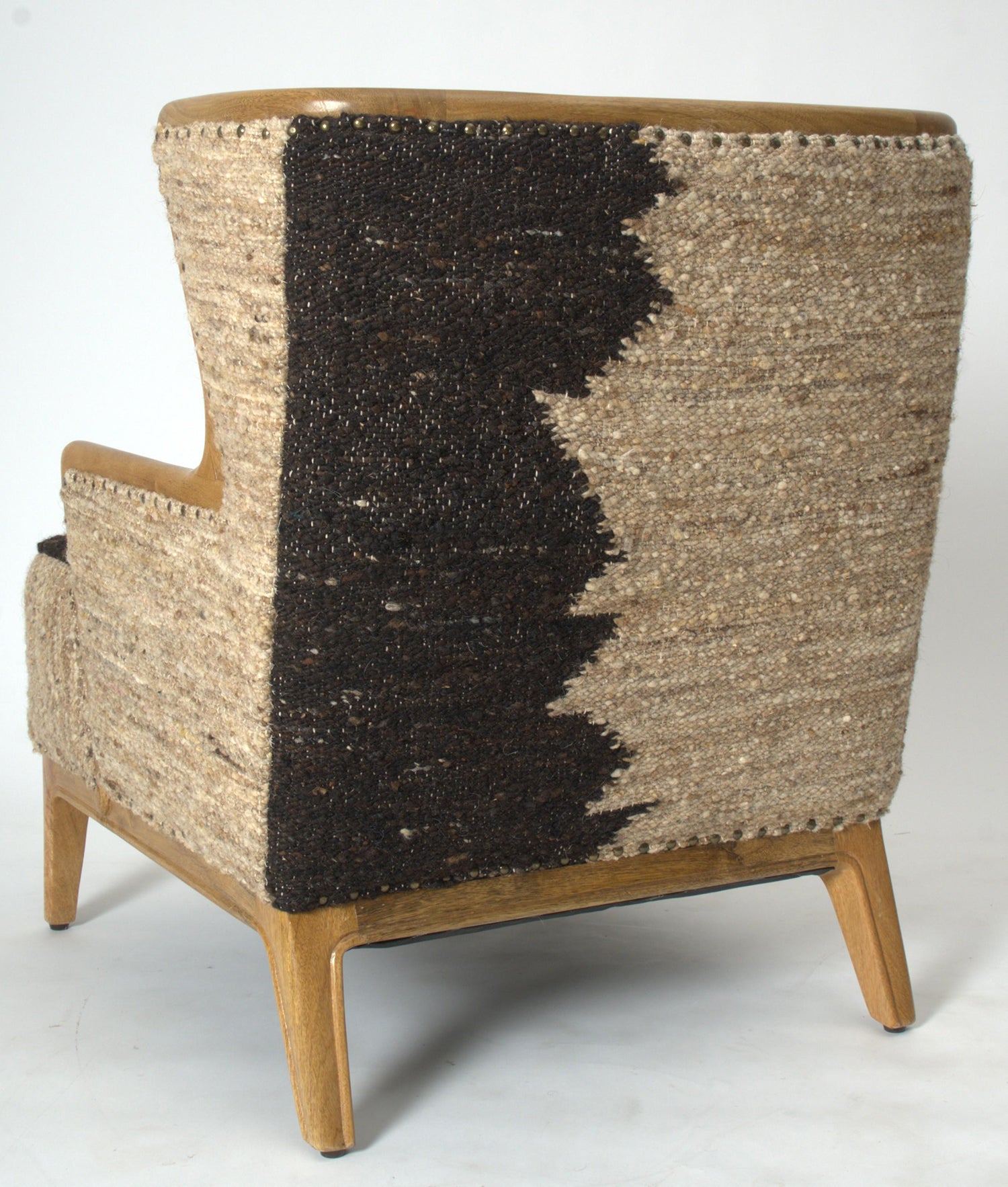 Vintage Sofa Company Ballari Accent Chair features a wingback inspired shape with exposed wooden frame and boucle style upholstery in cream and charcoal colours, with brass stud detail