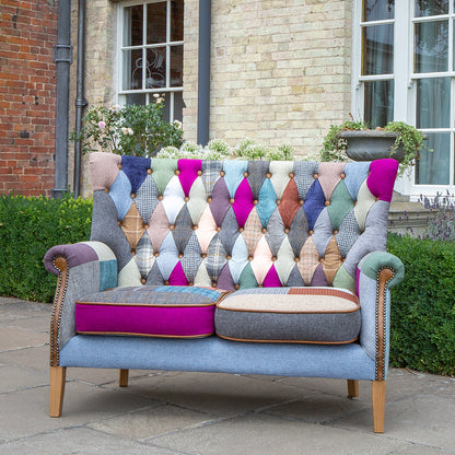 Vintage Sofa Company Barnard 2 Seater Sofa in a mixed patchwork upholstery, with padded seat cushions, scrolled arms and wooden legs