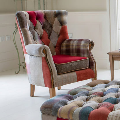 Vintage Sofa Company Barnard Patchwork Chair features a mix of fabrics with deep button tufting to the backrest, scrolled arms with brass stud details and wooden legs