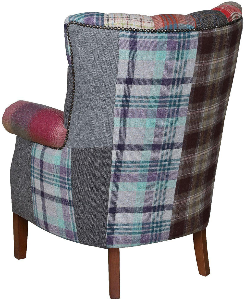 Vintage Sofa Company Barnard armchair features a patchwork mix of velvets, tweeds, checks and textured weaves, with brass stud detailing and wooden legs 