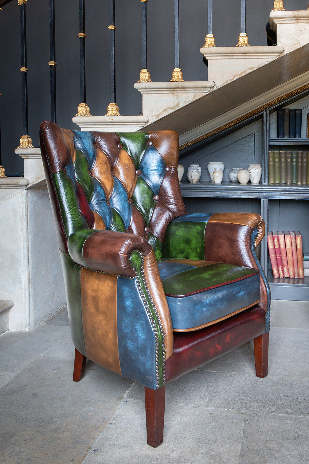 Vintage Sofa Company Bowes Rub-Off Leather Patchwork Chair with deep button tufting, scrolled arms and brass stud detailing