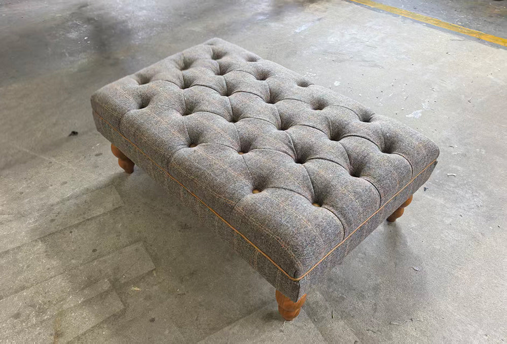 Vintage Sofa Company Buttoned Footstool in Fellwood Lodge Harrington Tweed grey toned upholstery, with deep button tufting, tan leather piping and turned wood feet