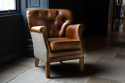 Vintage Sofa Company Buttoned Governor Chair In Tweed and Tan Leather With Medium Oak Legs in a room setting
