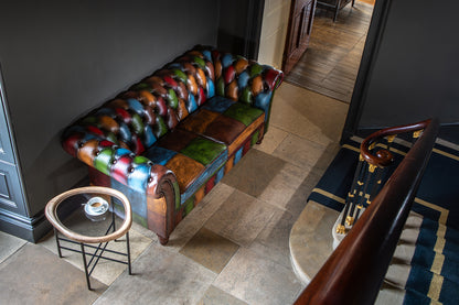 Vintage Sofa Company Chester Croft Rub Off Leather Patchwork 2 Seater Sofa features deep buttoning and rolled arms for a look that feels both classic and individual.