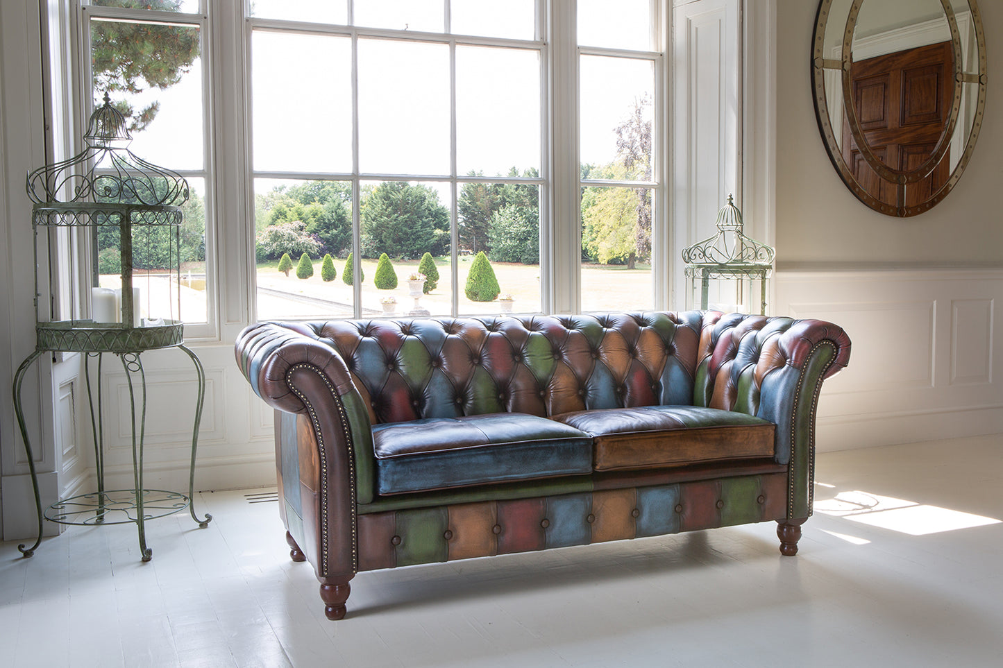 Vintage Sofa Company Chester Croft Rub Off Leather Patchwork 2 Seater Sofa with its chesterfield inspired design features deep button tufting, rolled arms, brass stud details and turned wooden feet