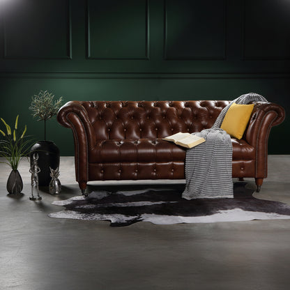 Vintage Sofa Company Chester Oliato 2 Seater Sofa is a chesterfield style of sofa with classic diamond quilting across the backrest, arms and seat, scrolled arms feature brass stud detailing and the turned wooden legs also have castors to the front for easy movement