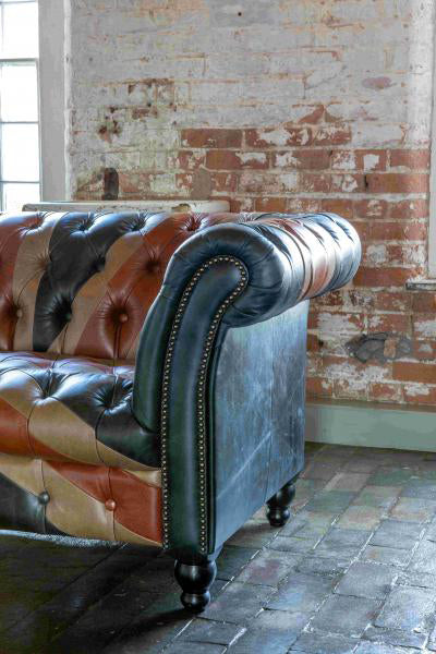 Vintage Sofa Company Chester Union Jack 2 Seat Chesterfield Sofa in Leather with deep button tufting, scrolled arms, brass stud detail and black turned wooden legs