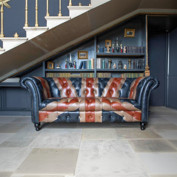 Vintage Sofa Company Chester Union Jack 2 Seat Chesterfield Leather Sofa. The Union Jack layout brings colour, identity and a strong sense of personality, while the deep button tufting, scrolled arms and brass stud edging keep the sofa tied to traditional upholstery.