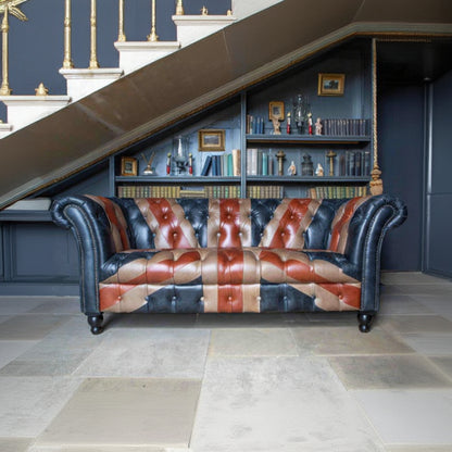 Vintage Sofa Company Chester Union Jack 2 Seat Chesterfield Leather Sofa. The Union Jack layout brings colour, identity and a strong sense of personality, while the deep button tufting, scrolled arms and brass stud edging keep the sofa tied to traditional upholstery.