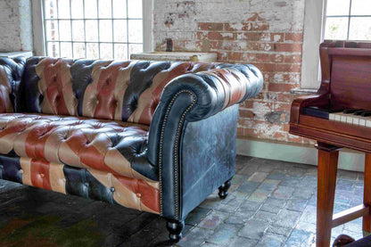 Vintage Sofa Company Chester Union Jack 2 Seat Chesterfield Sofa in Leather features deep buttoning, rolled arms, brass stud detailing and black turned feet 