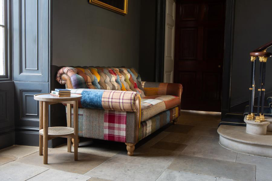 Vintage Sofa Company Dickinson 2 Seat Medium Sofa Upholstered In Mixed Patchwork Fabrics with Tan Leather Panels and turned wooden feet