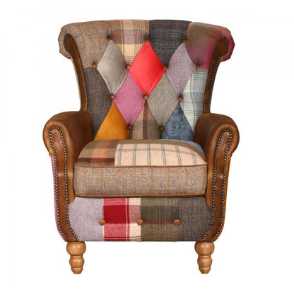 Vintage Sofa Company Dickinson Armchair features warm-toned patchwork and Cerato brown leather to give the chair a more tailored take on the statement chair, with high buttoned back, rolled arms, brass stud detailing and turned wooden legs