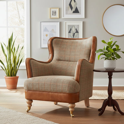 Vintage Sofa Company Ellis Wingback Chair in Hunting Lodge Harris Tweed Fabric and Tan Leather, with brass stud detailing and turned wooden feet with front castors