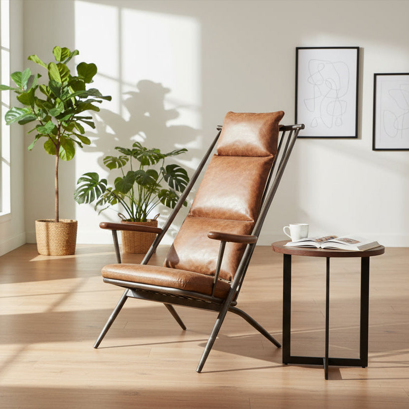 Vintage Sofa Company Ely Studio Chair features a black metal frame with wooden armrests, and a warm brown leather padded seat and backrest cushions 