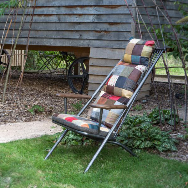Vintage Sofa Company Ely Patchwork Studio Chair features a black metal reclining frame that can be folded for storage, and a vibrant patchwork padded upholstery with bohemian flair