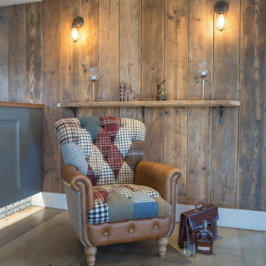 Vintage Sofa Company Gotham Patchwork Armchair with Harris Tweed Fabric Sides, tan leather rolled arms with brass stud detailing, and plush deep buttoned patchwork upholstery to the the high back and seat