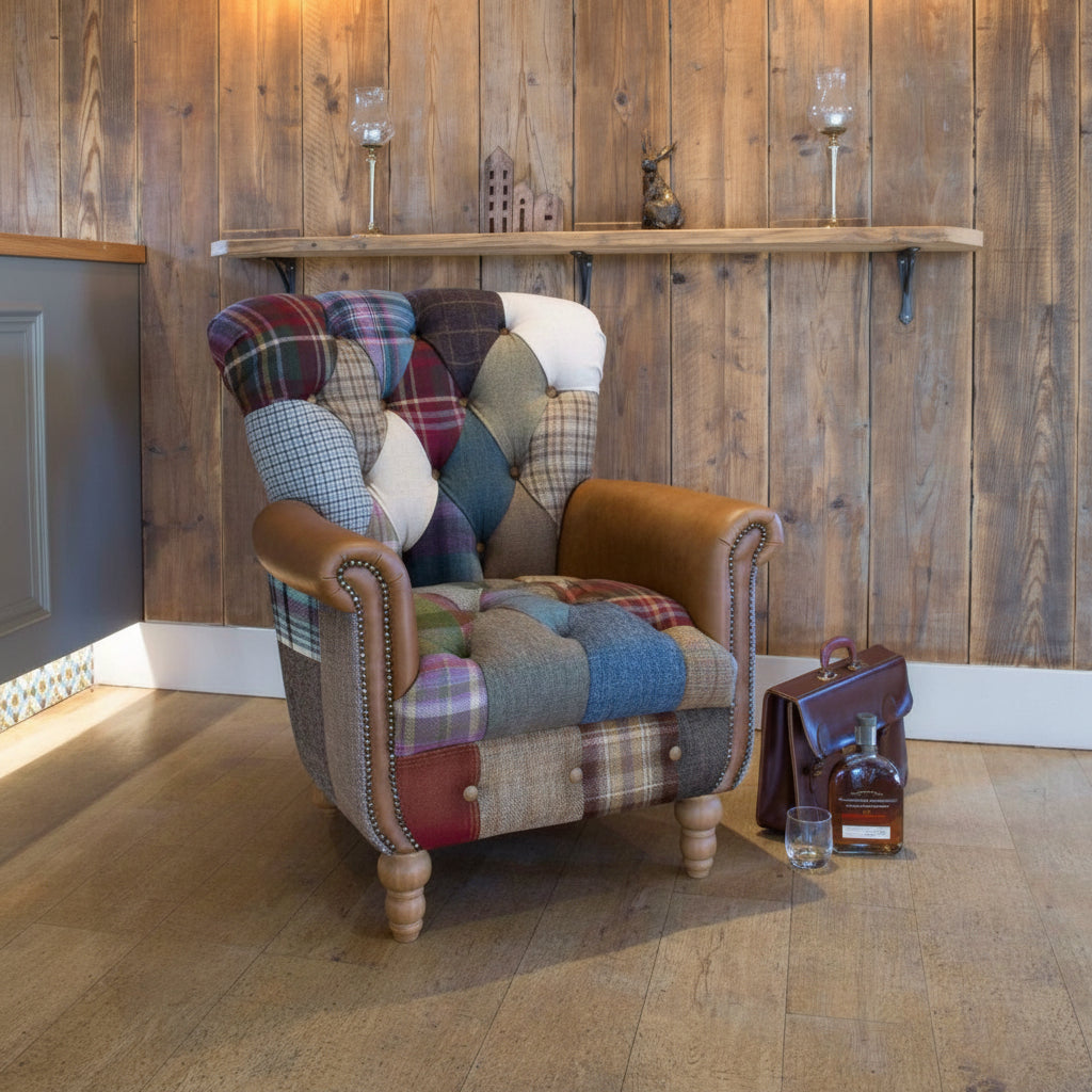 Vintage Sofa Company Gotham Patchwork Armchair with Patchwork Sides and Tan Leather trimmed rolled arms with brass stud detailing, deep button tufting and turned wooden legs.