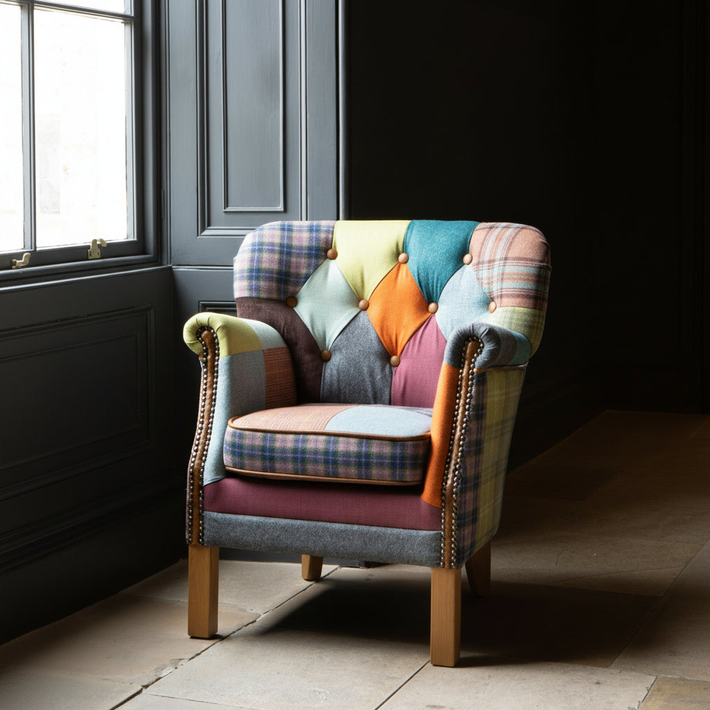 The Vintage Sofa Company Governor Armchair is upholstered in a vibrant Patchwork fabric with tan leather accents and brass stud detailing 