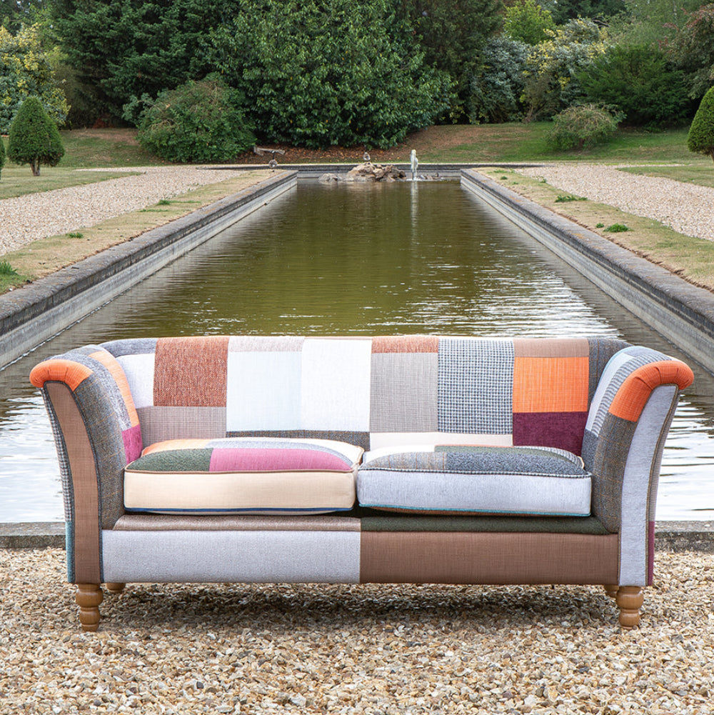 Vintage Sofa Company Granby 2 Seater Plain Back Sofa in Patchwork fabric with rolled arms, generously padded seat cushions and turned wooden legs