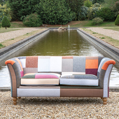 Vintage Sofa Company Granby 2 Seater Plain Back Sofa in Patchwork fabric with rolled arms, generously padded seat cushions and turned wooden legs