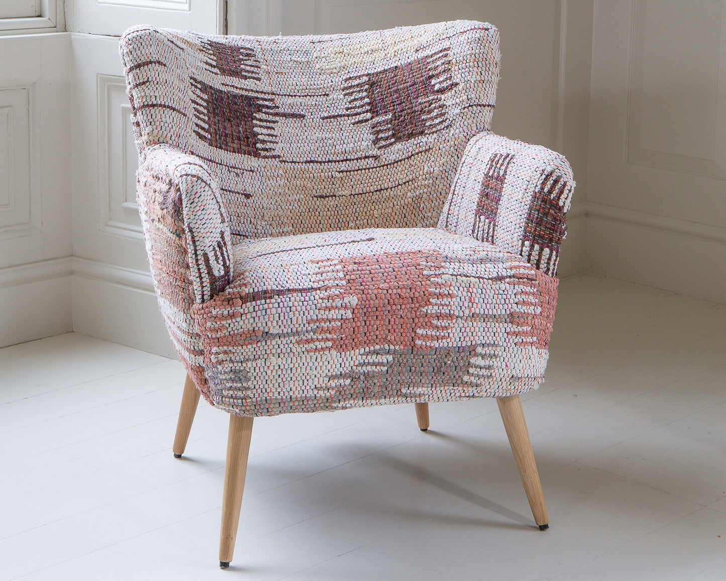Vintage Sofa Company Hansi Chair is upholstered in soft muted tones with a chunky woven fabric and a broken geometric pattern