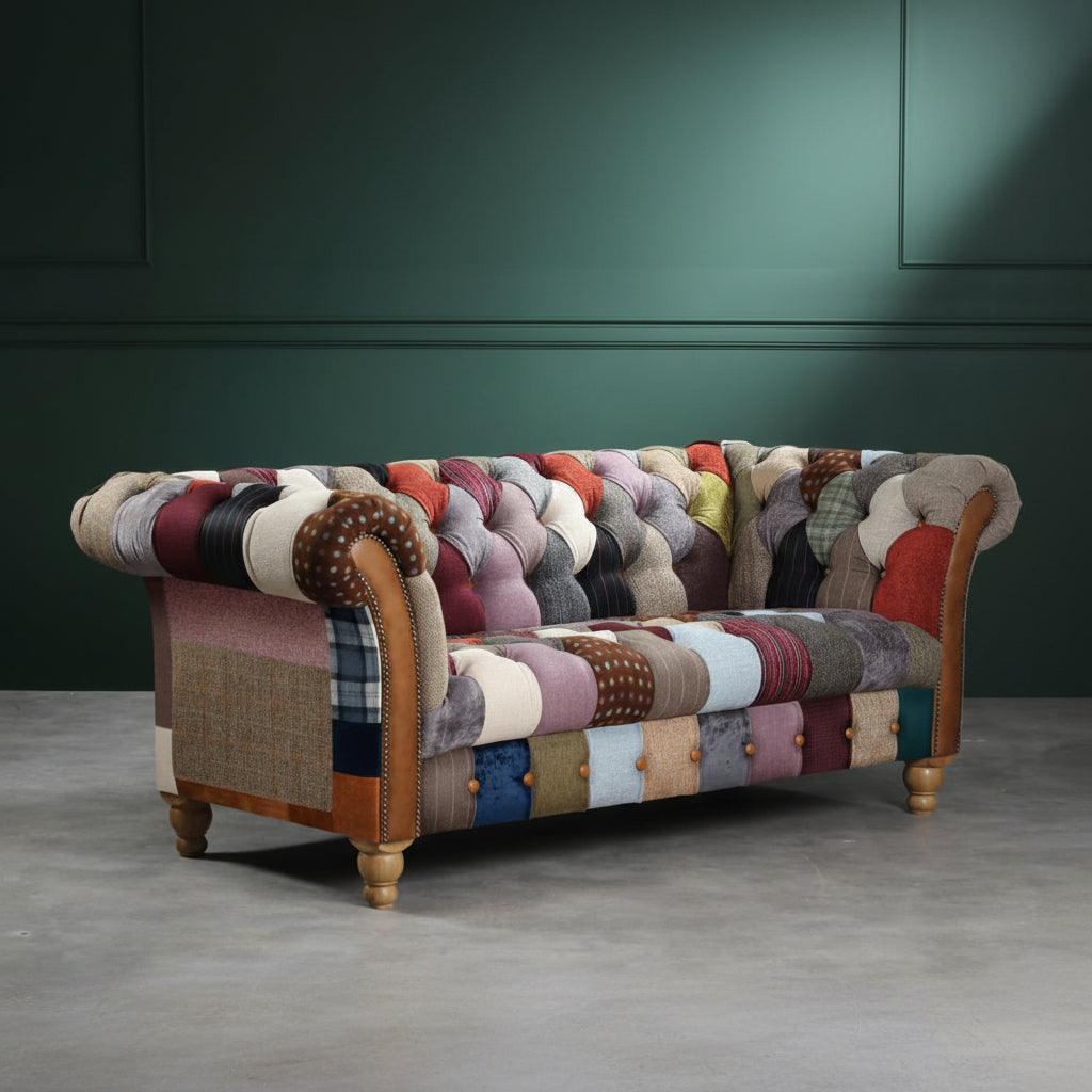 Vintage Sofa Company Harlequin 2 Seat Chesterfield Sofa is upholstered is Patchwork across the back, seat, rolled arms and outer sides, with tan leather details, deep buttoning and turned wooden feet.