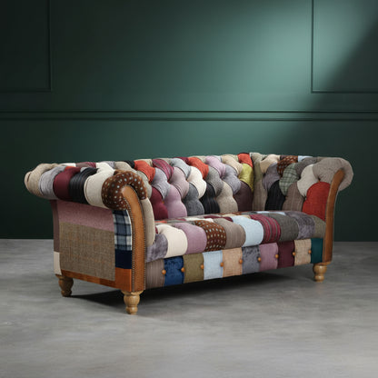 Vintage Sofa Company Harlequin 2 Seat Chesterfield Sofa is upholstered is Patchwork across the back, seat, rolled arms and outer sides, with tan leather details, deep buttoning and turned wooden feet.