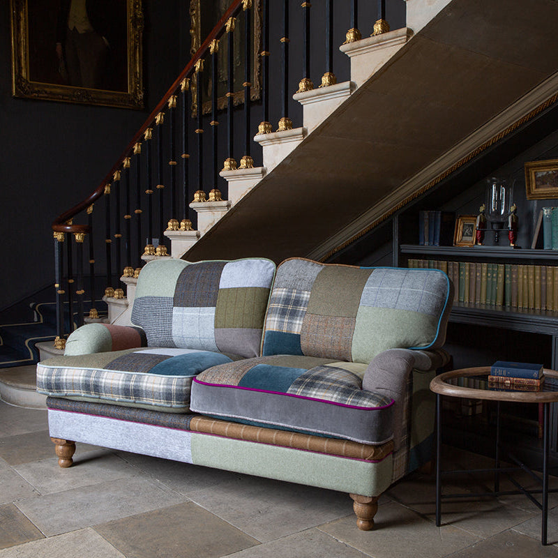 Vintage Sofa Company Hawksworth 2.5 Seater Sofa uses muted patchwork to bring texture and character without overpowering the room, featuring rolled arms, deep seat cushions and turned wooden feet.