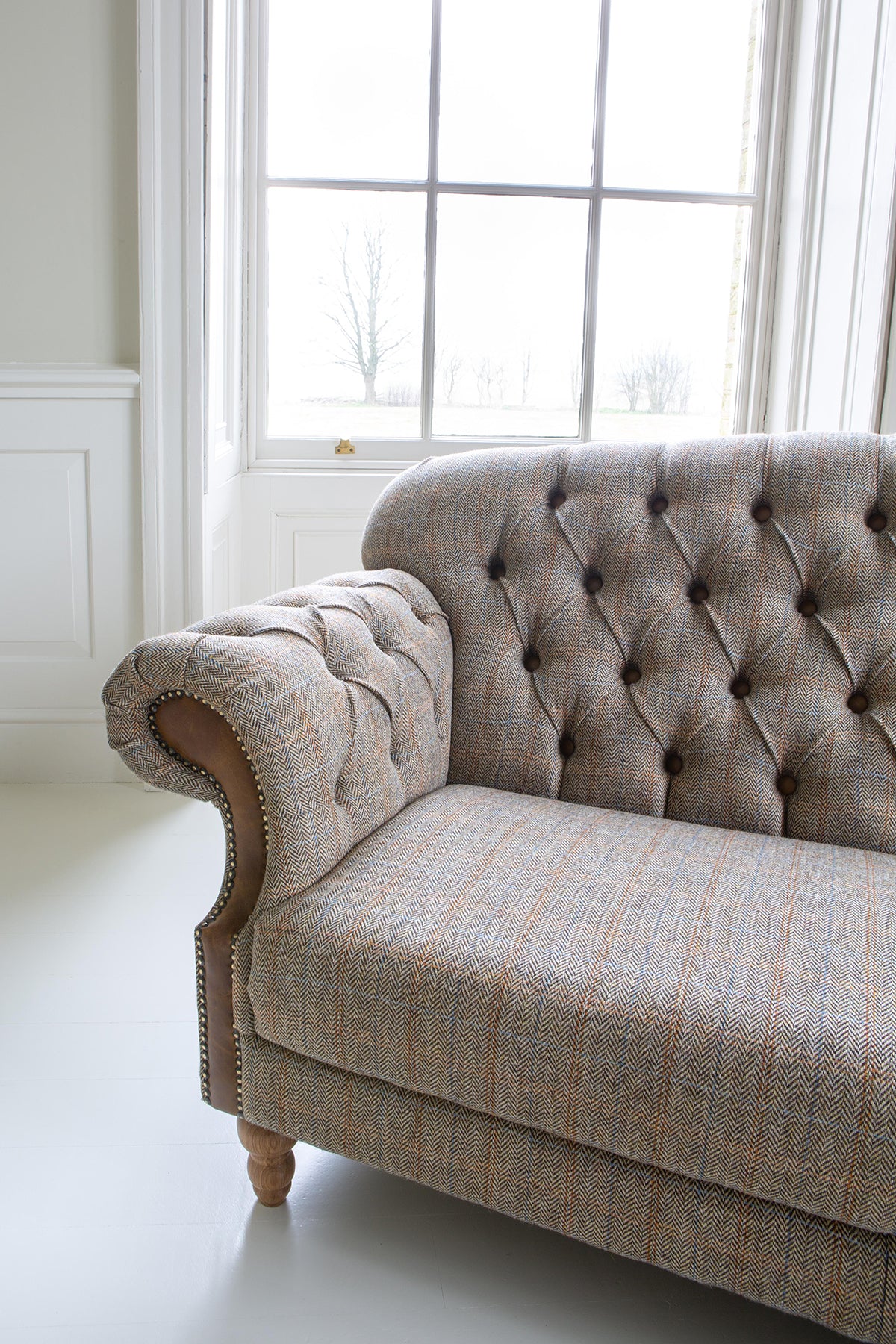 Vintage Sofa Company Haworth 2 Seater Sofa in Hunting Lodge tweed button tufted fabric with scrolled arms and brass stud detailing, and turned wooden legs 