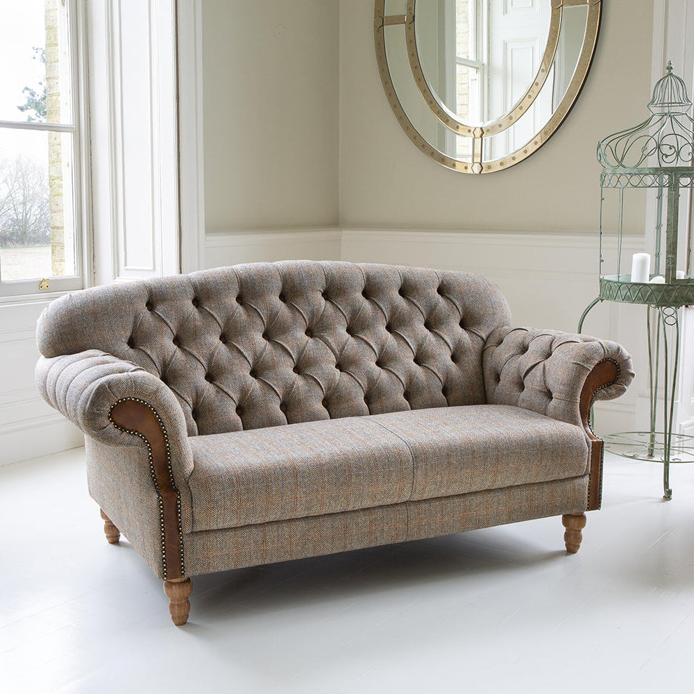 Vintage Sofa Company Haworth 2 Seater Sofa in Hunting Lodge neutral toned fabric, features deep button tufting to the back and arms, tan leather accents and medium oak wood legs
