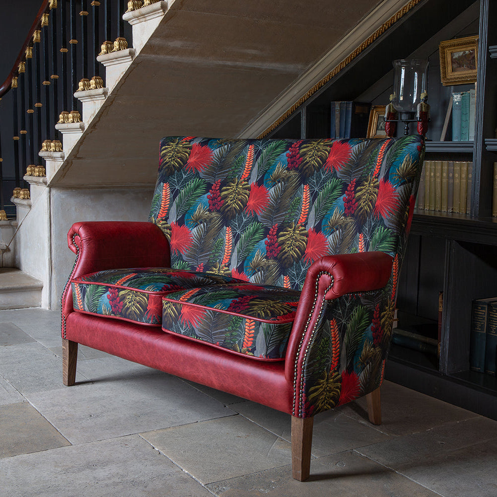 Vintage Sofa Company Hexham 2 Seater features a bold pattern, rich Rosso leather that give the Hexham far more presence than its size suggests. Toucan fabric adds movement and colour, while the antique waxed legs keep the overall look grounded and furniture-led.