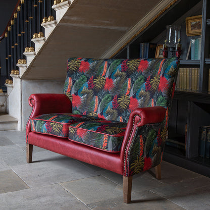 Vintage Sofa Company Hexham 2 Seater features a bold pattern, rich Rosso leather that give the Hexham far more presence than its size suggests. Toucan fabric adds movement and colour, while the antique waxed legs keep the overall look grounded and furniture-led.