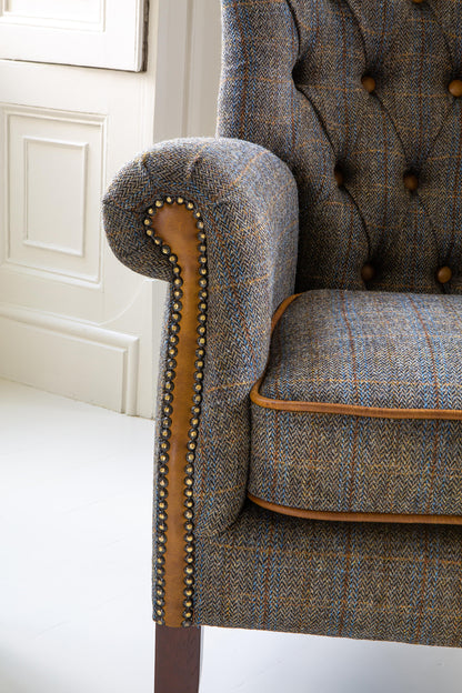 Vintage Sofa Company Hexham Chair Upholstered in Moreland Harris Tweed fabric with leather trim and brass stud detail.